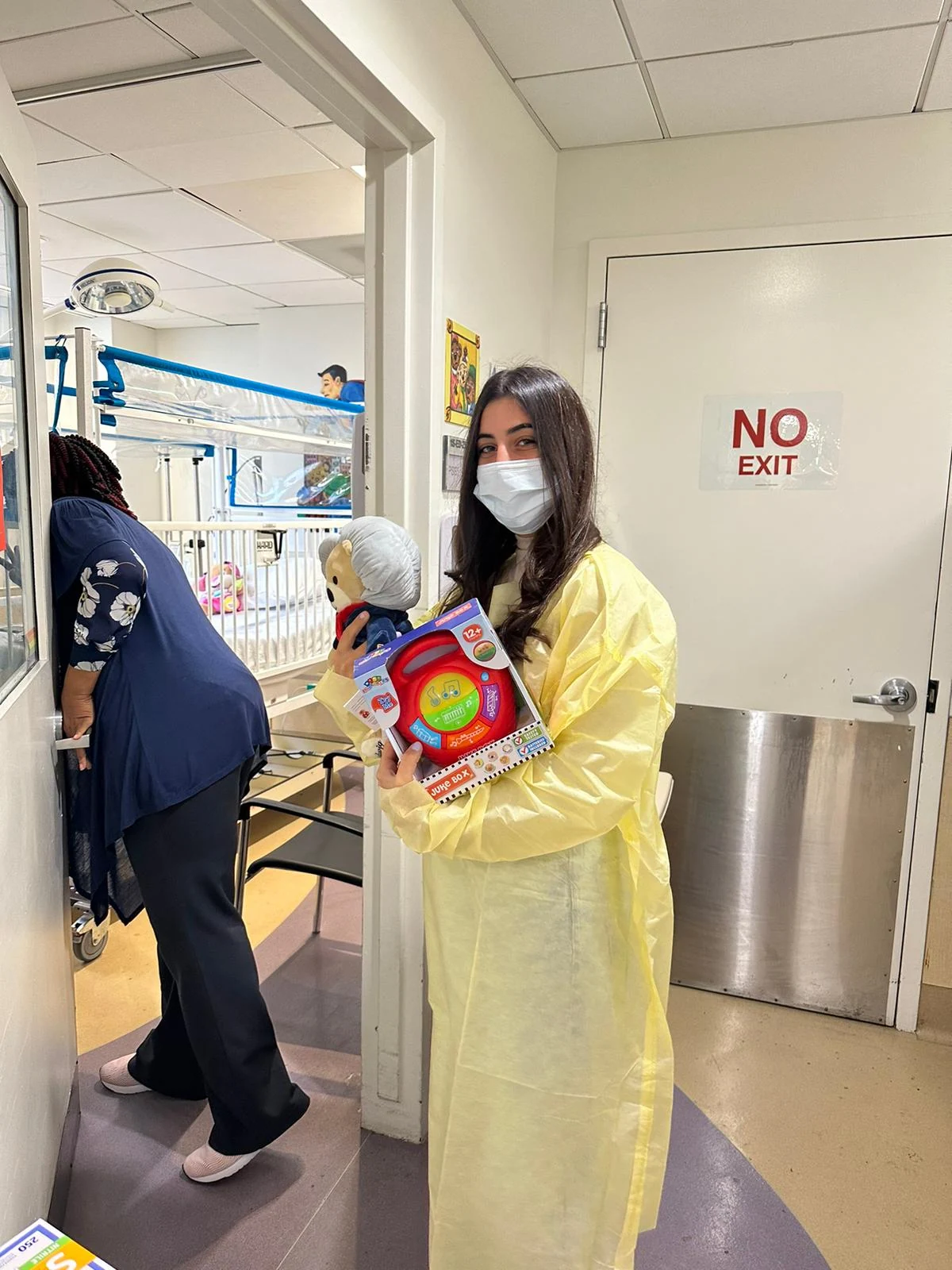 A volunteer carrying toys during a hospital visit