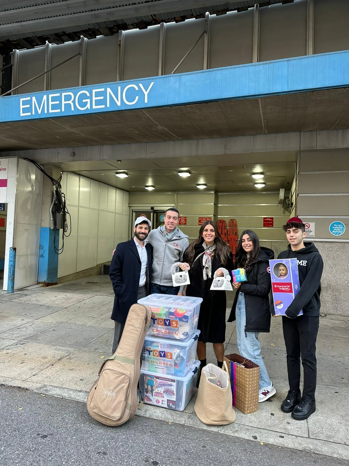 Volunteers outside a hospital with donated toys