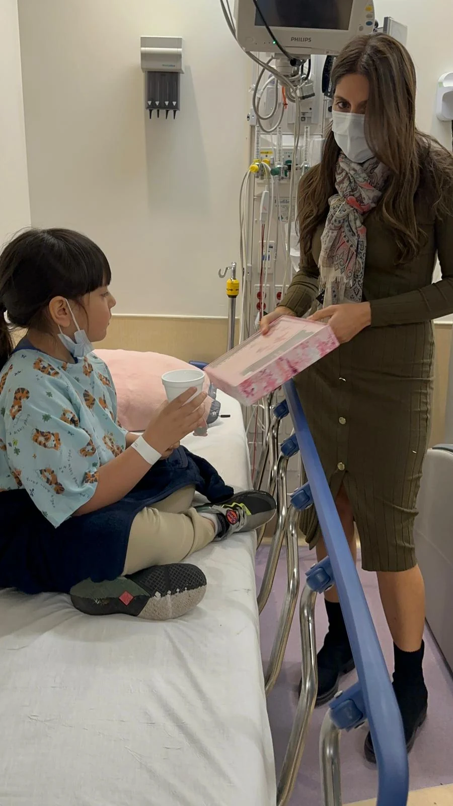 A volunteer offering a toy during a hospital visit
