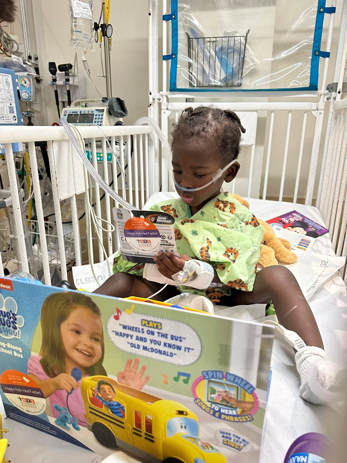 A child with donated toys during the hospital visit