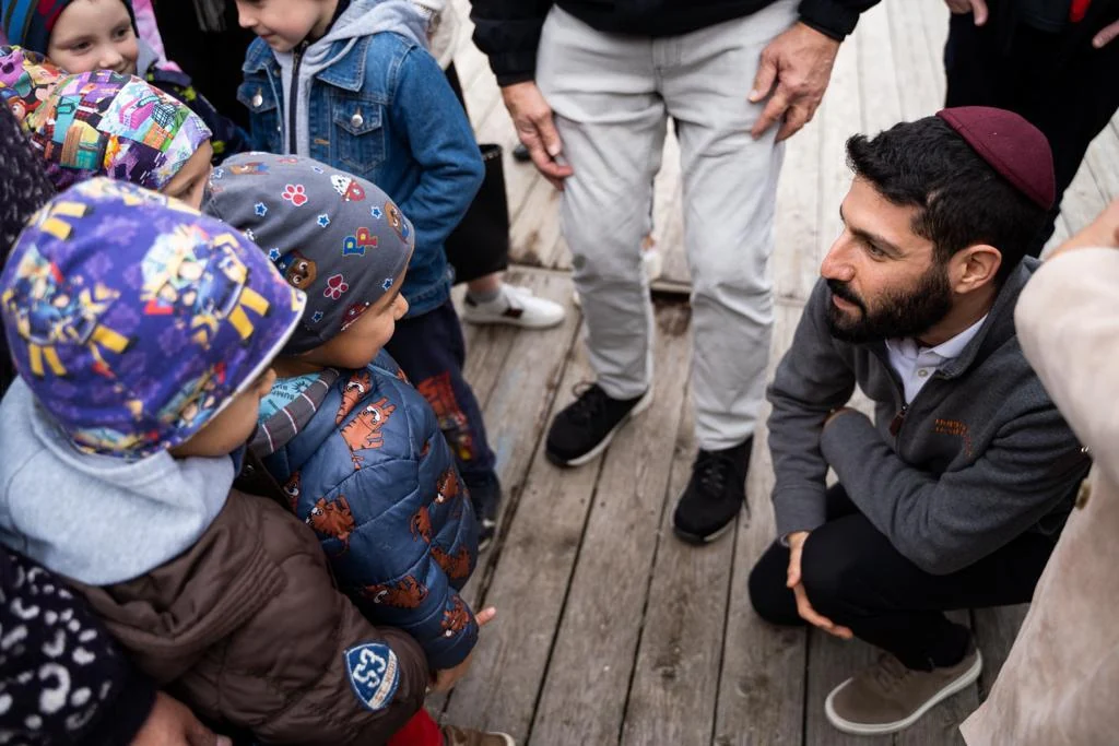 A volunteer sharing donated gifts with children