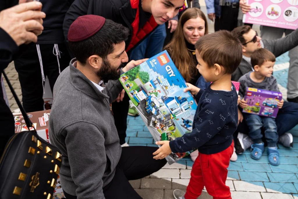 A volunteer speaking with children during the visit