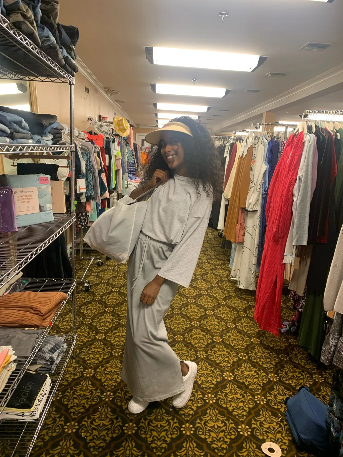 A participant choosing clothing from a rail