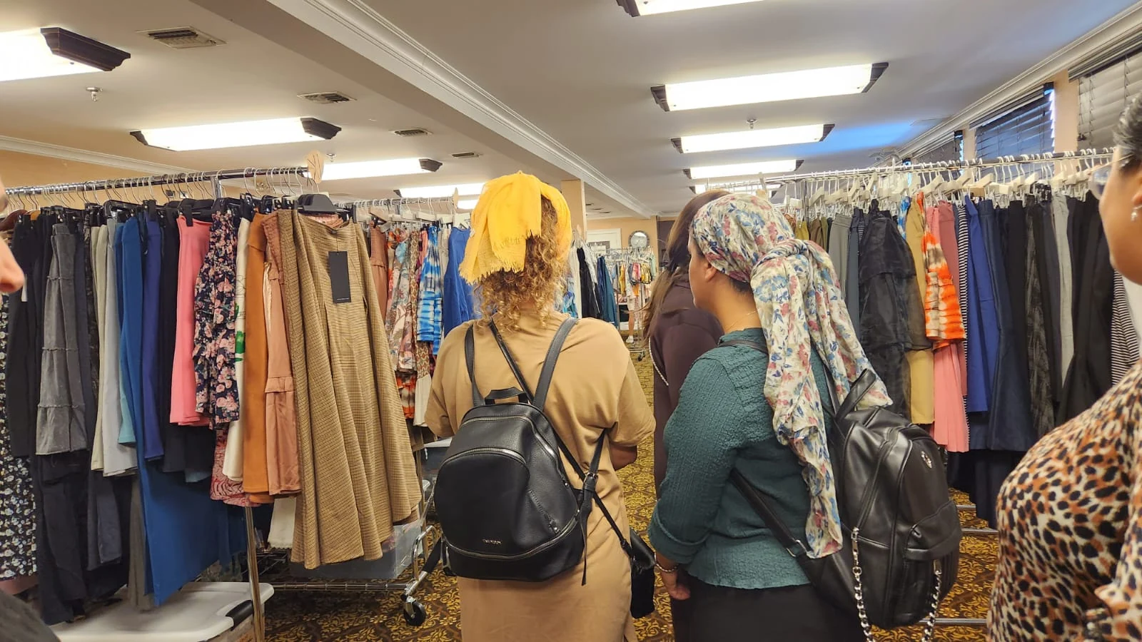 Participants and volunteers together among clothing rails